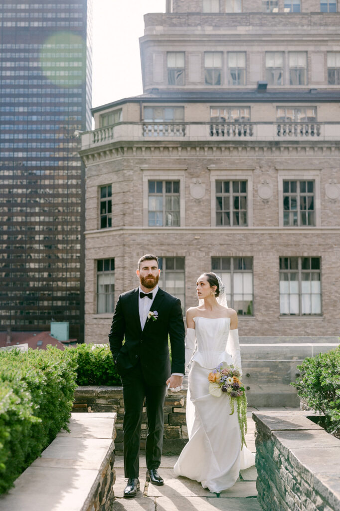 bride and groom holding hands during their wedding photoshoot