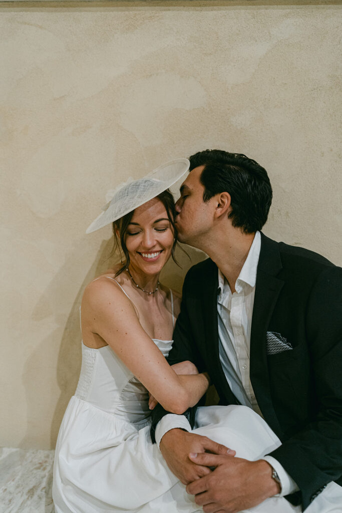 fiance kissing his fiance on the cheek