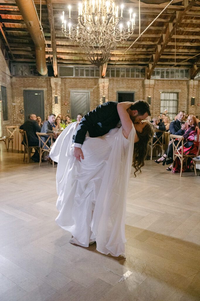 bride and groom kissing at their wedding reception