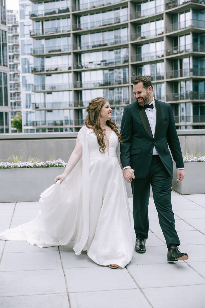 bride and groom holding hands walking around the hotel