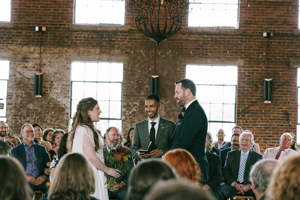 bride and groom holding hands at their wedding ceremony