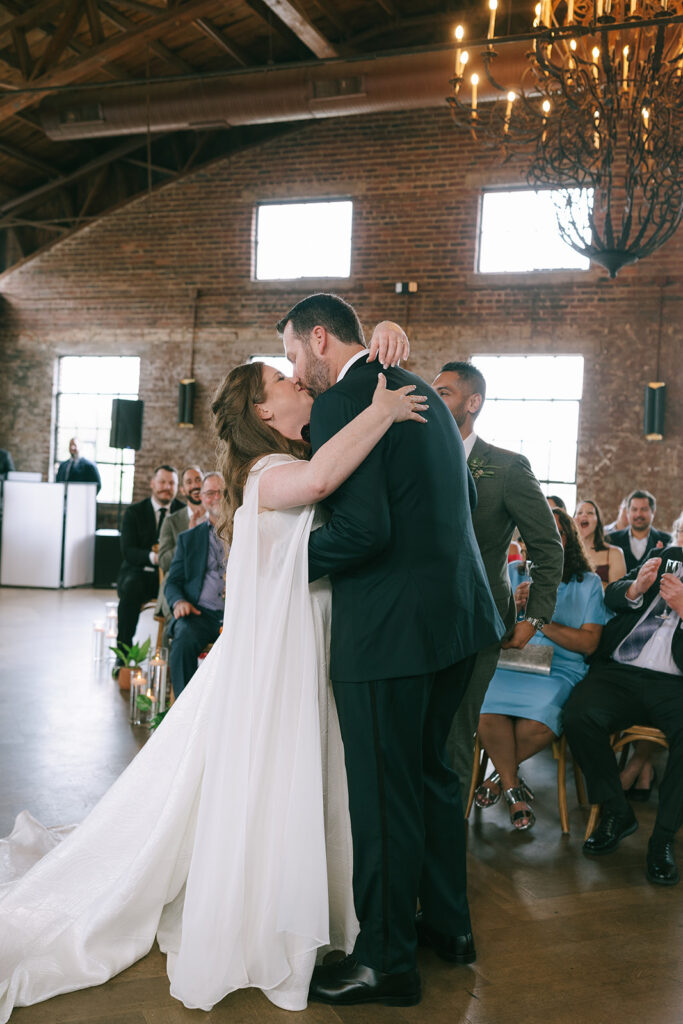 bride and groom kissing after their wedding ceremony 