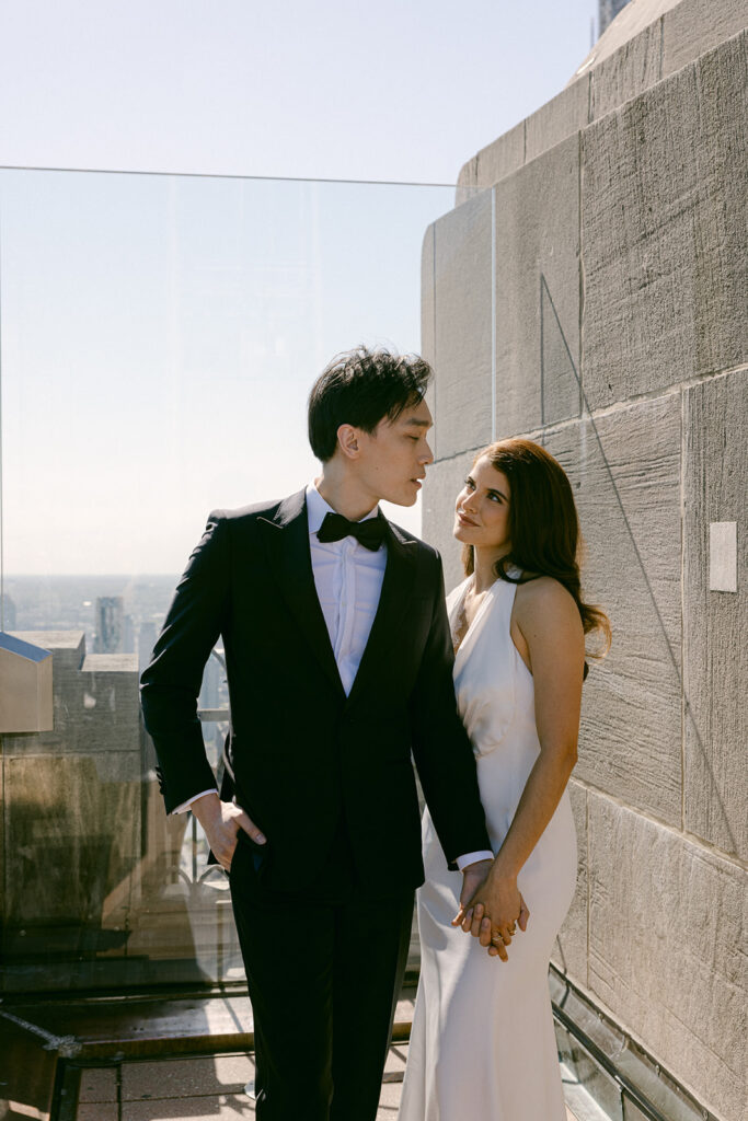 couple holding hands looking at each other 