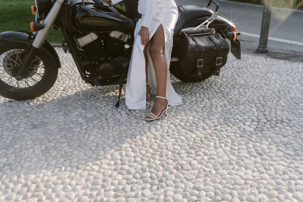 couple riding a motorcycle around lake como