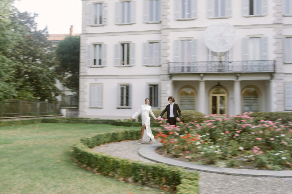 engaged couple walking around a garden in lake como