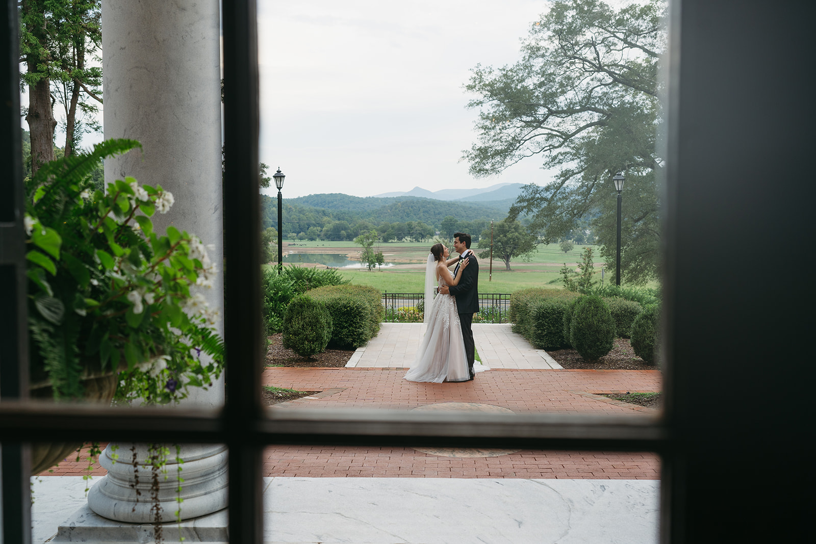 bride and groom hugging before heading to their old money wedding reception