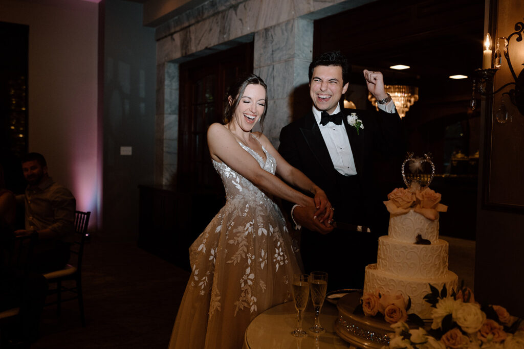 bride and groom cutting their wedding cake 