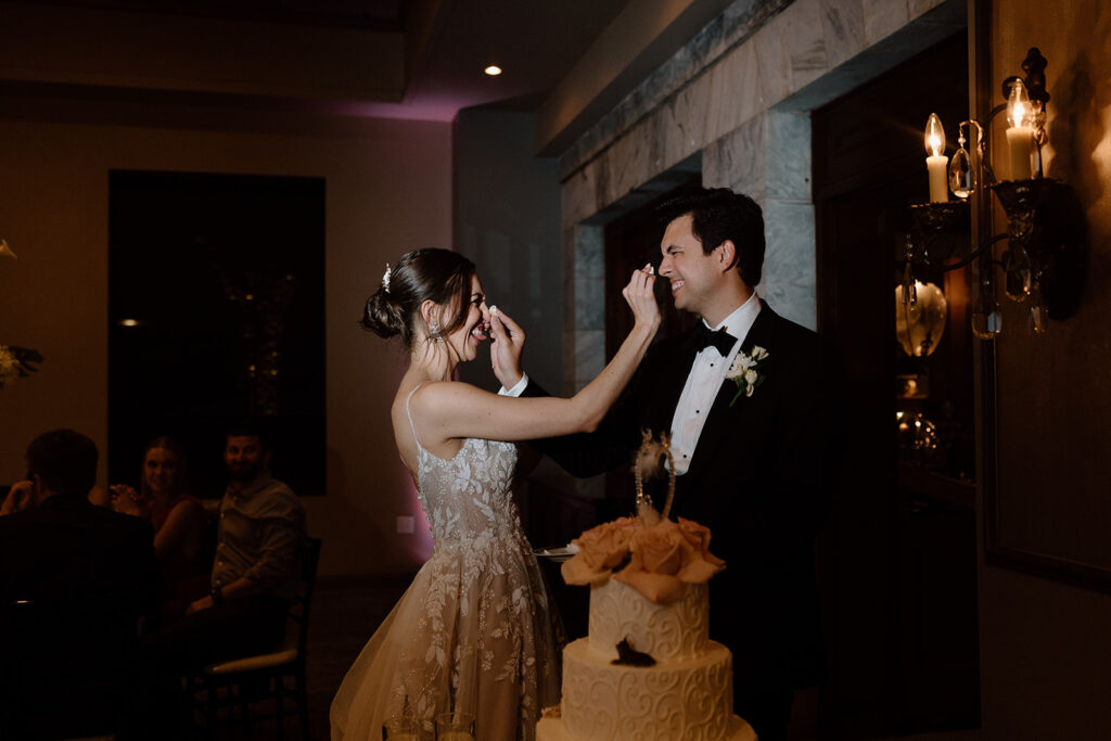 bride and groom trying their wedding cake