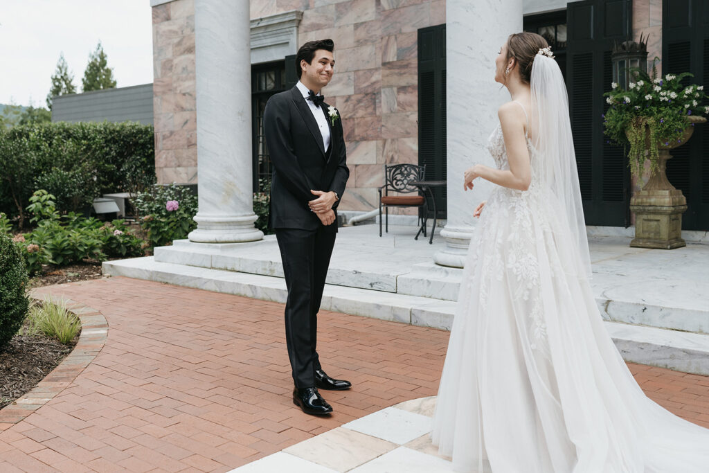 groom seeing the bride in her wedding dress for the first time