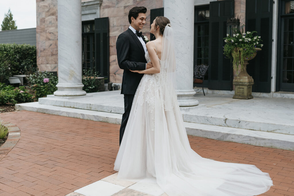 bride and groom hugging looking at each other 