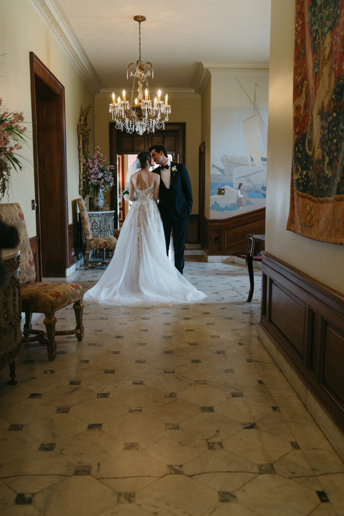 bride and groom kissing at their old money wedding