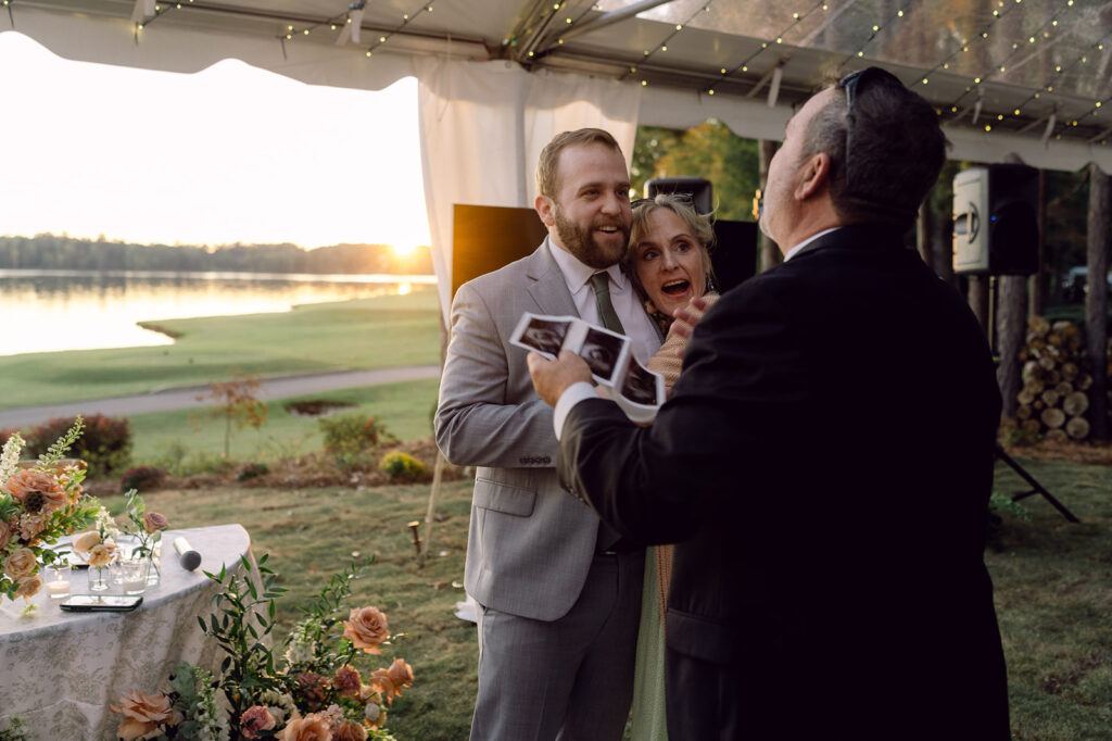 couple announcing their pregnancy at their wedding reception