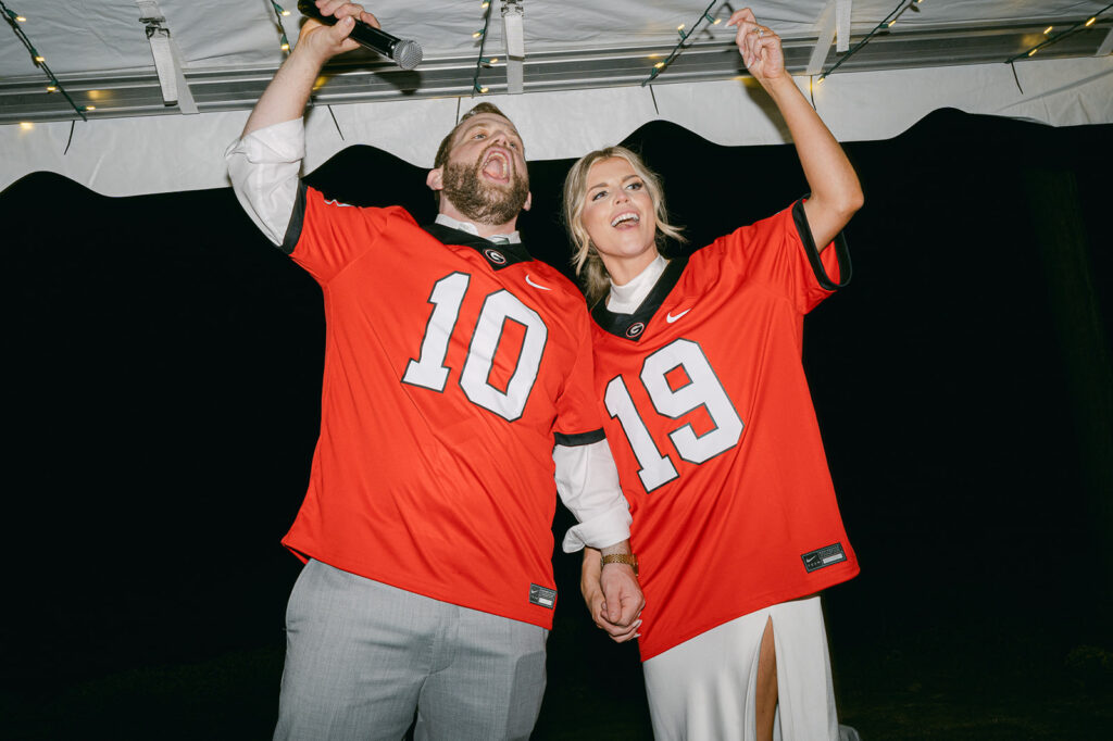 cute couple wearing their sports jerseys at their wedding reception