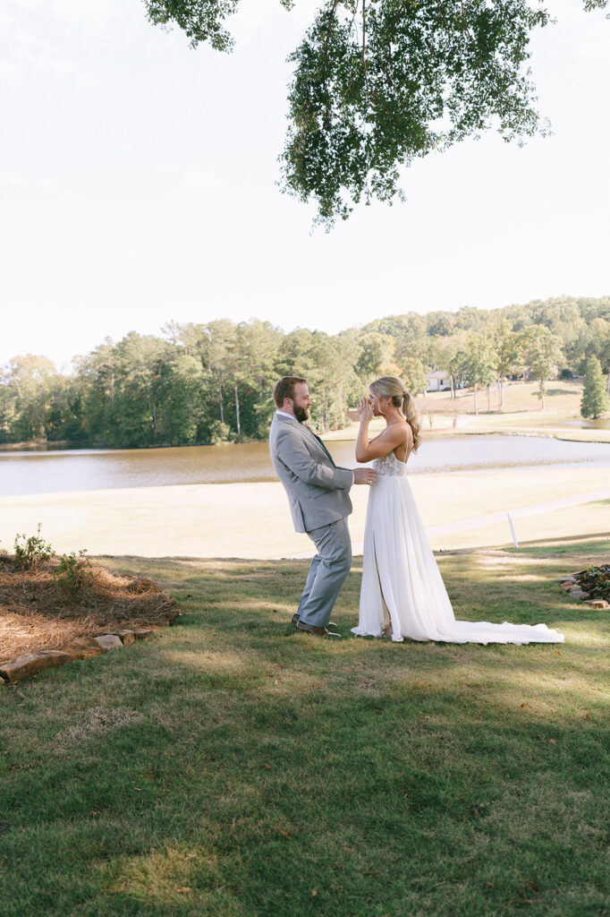 groom emotional at his first look with the bride at the lake house wedding