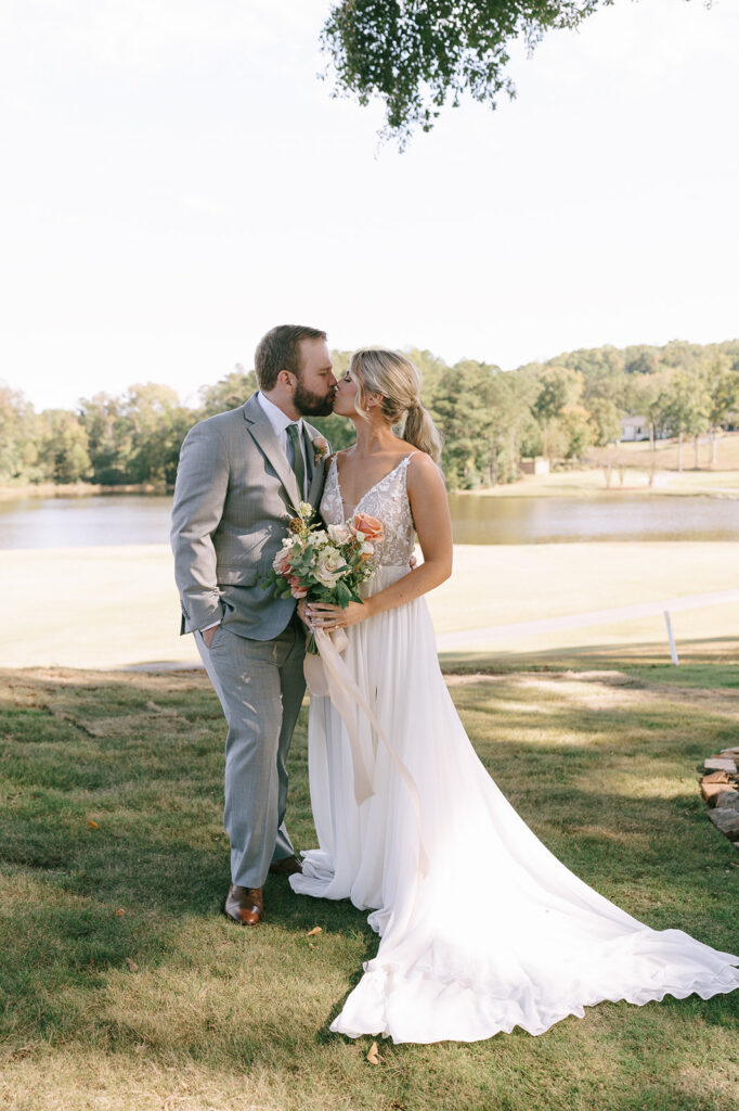 picture of the bride and groom kissing 