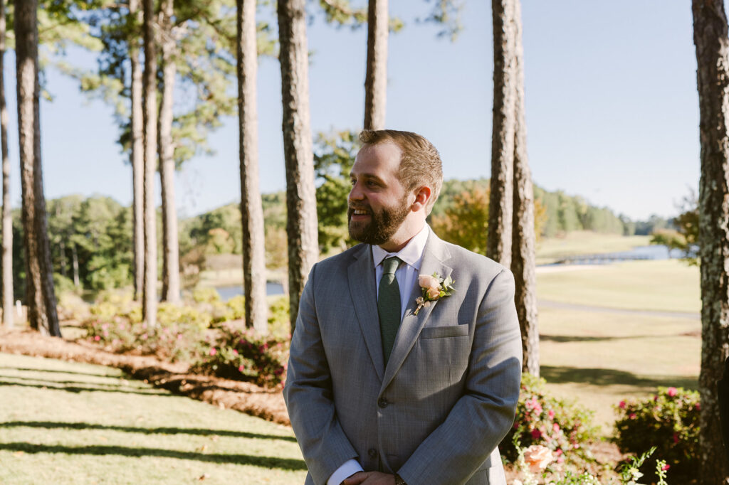 groom watching the bride walk down the aisle 