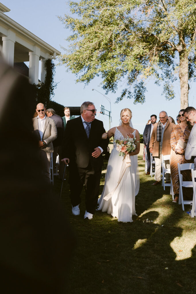 cute picture of the bride walking down the aisle 