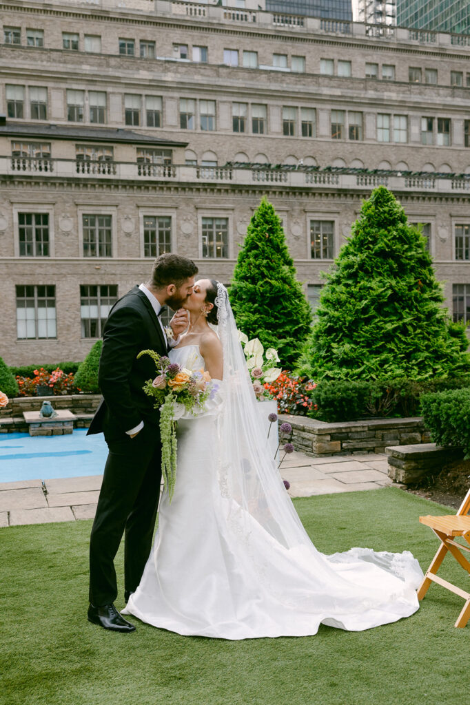 portrait of the bride and groom kissing