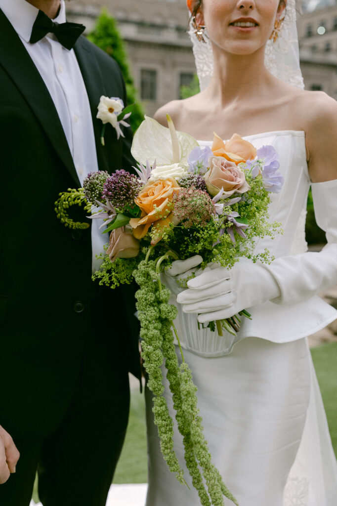 bride holding her colorful wedding bouquet 