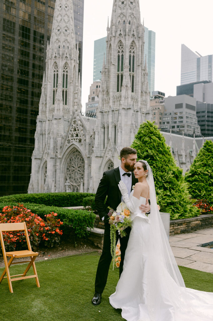 groom kissing the bride on the forehead 