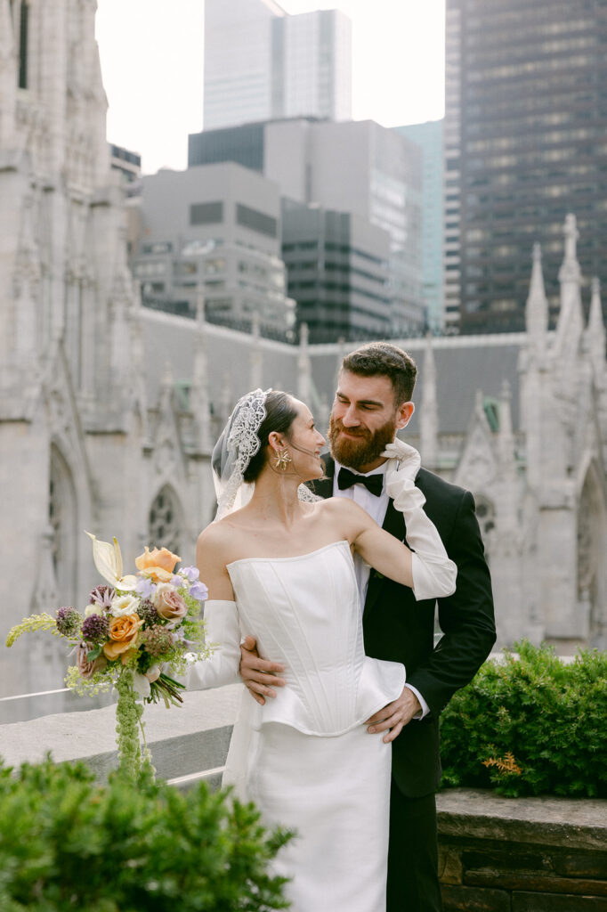 bride and groom looking and smiling at each other 