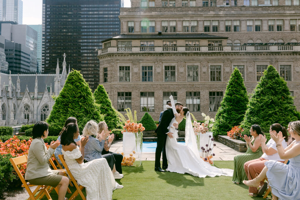 bride and groom kissing after their wedding ceremony 