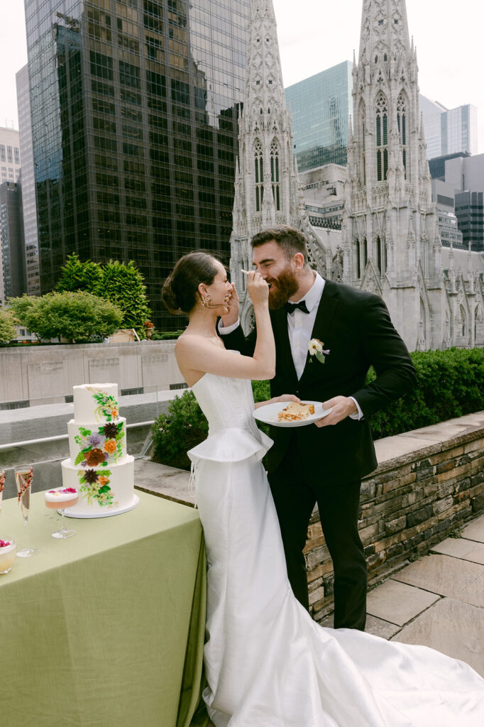 bride and groom trying their wedding cake 