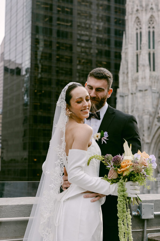 groom kissing the bride on the cheek