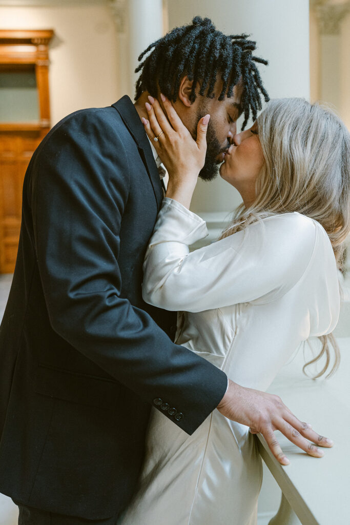 newly engaged couple kissing