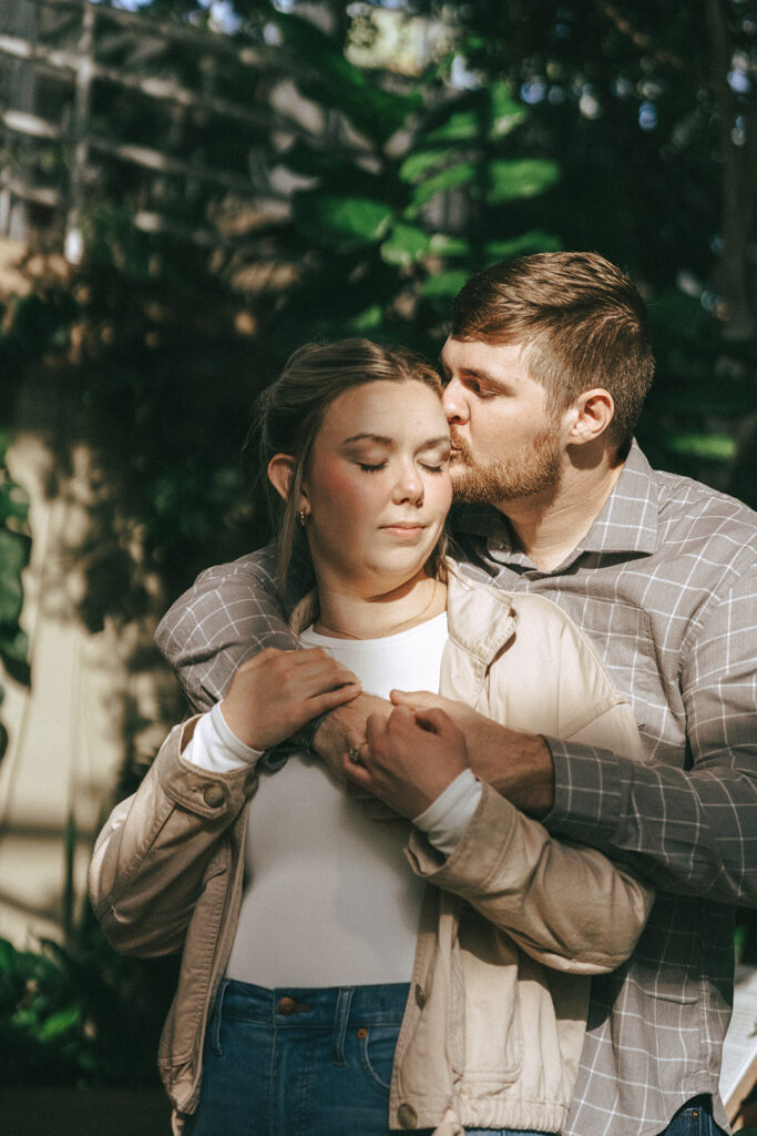 fiance kissing his fiance on the cheek