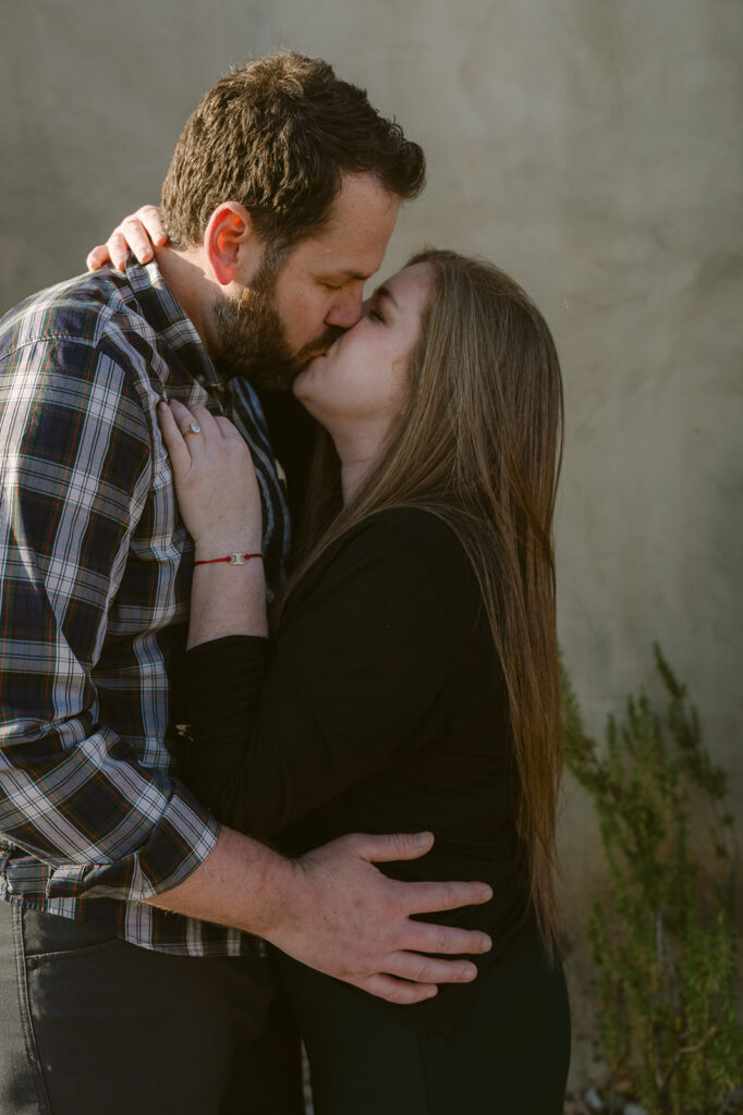 newly engaged couple kissing 