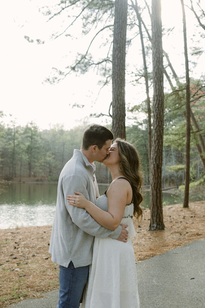 newly engaged couple kissing