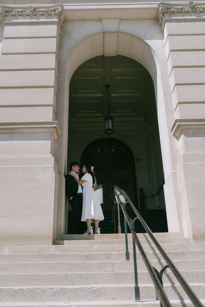 couple kissing during their proposal photoshoot at atlanta city hall