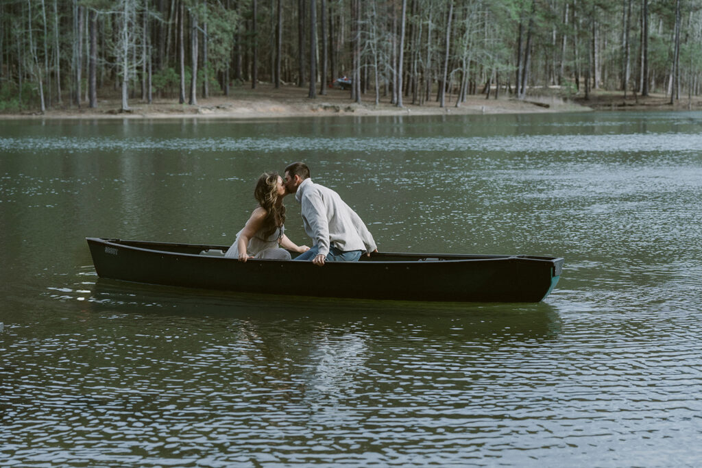 cute couple kissing during their engagement session at the lake