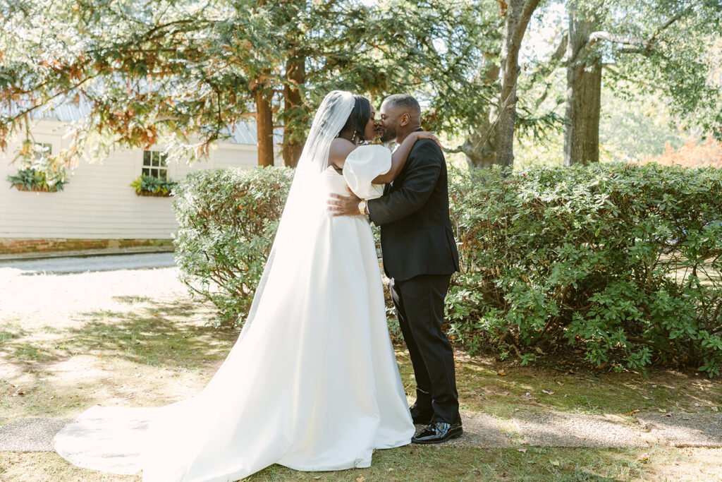 bride and groom kissing after their first look