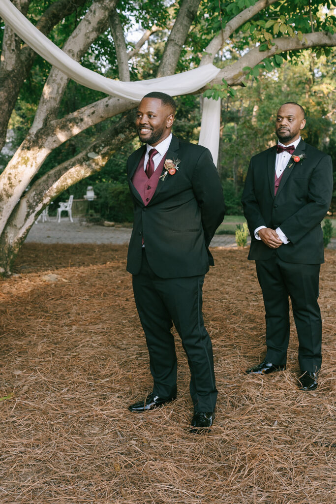 groom watching the bride walk down the aisle 