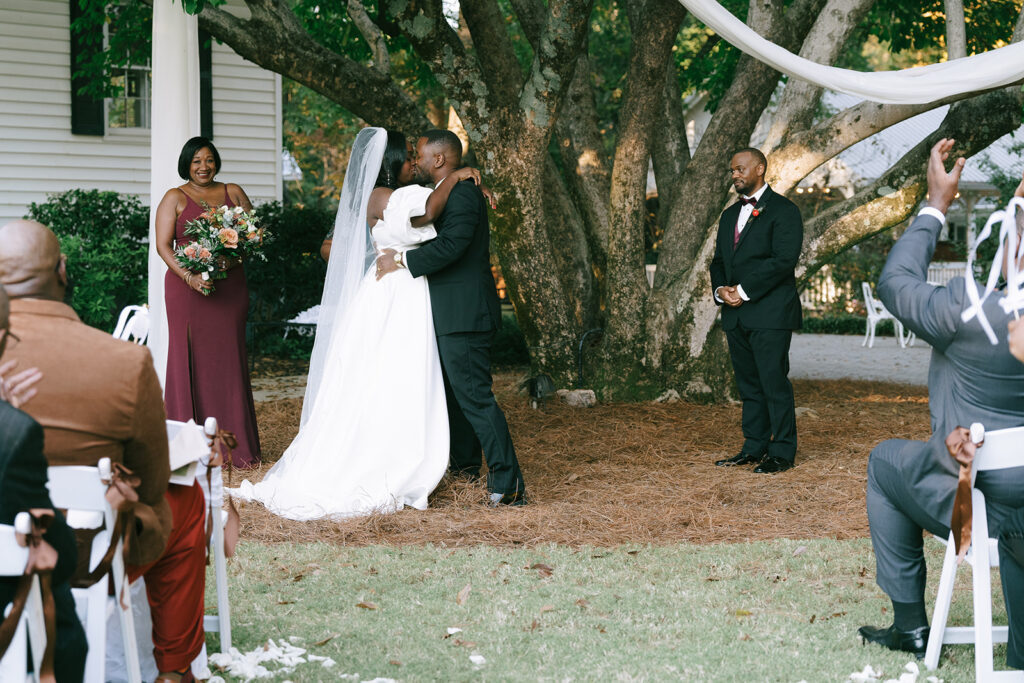 bride and groom kissing after their wedding ceremony 