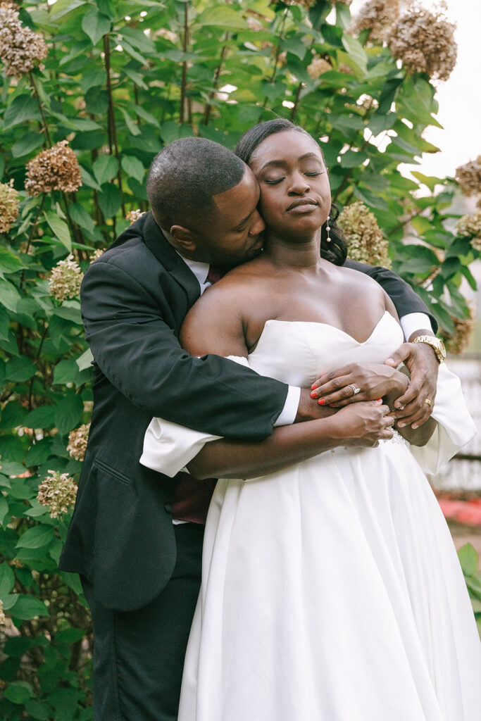 groom kissing the bride on the cheek