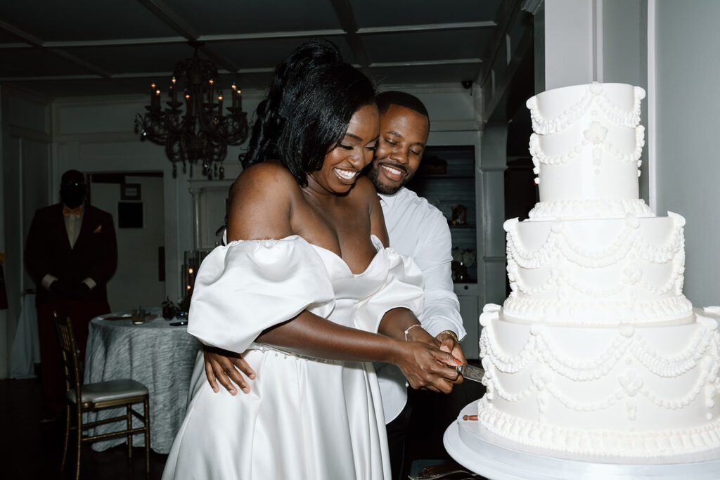 bride and groom cutting their wedding cake