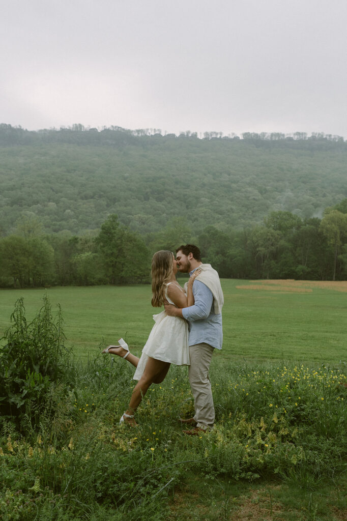 newly engaged couple kissing