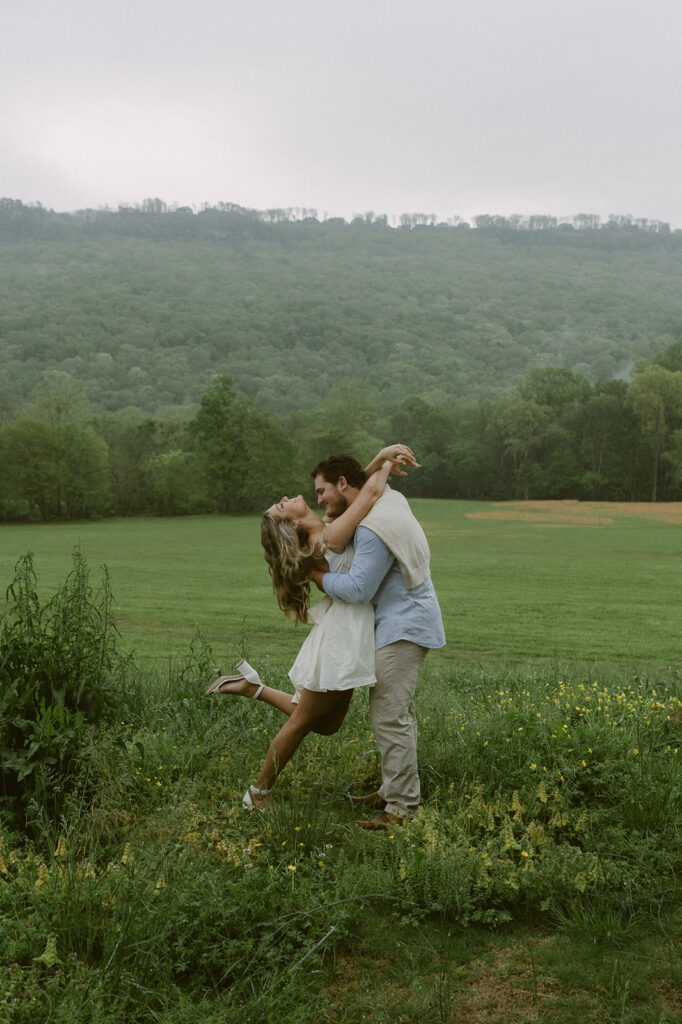 couple dancing during their rainy engagement session