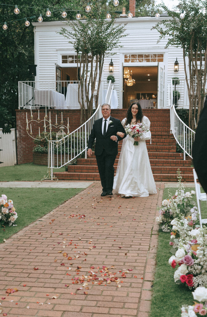 bride walking down the aisle for her coquette themed wedding ceremony 