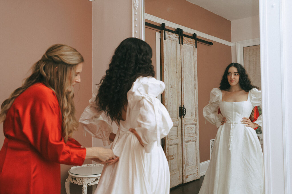 mother of the bride helping the bride get ready for the ceremony