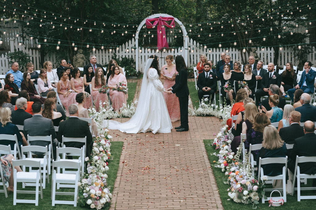 bride and groom holding hands during their wedding ceremony 