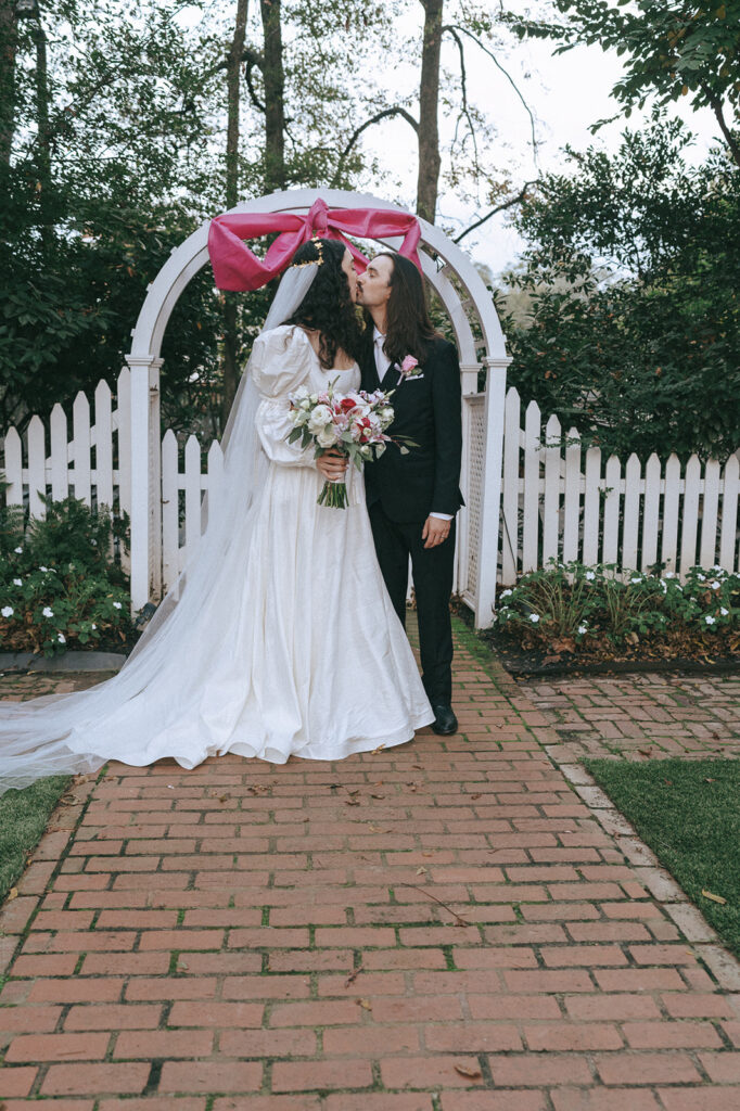 newly married couple kissing during their photoshoot 