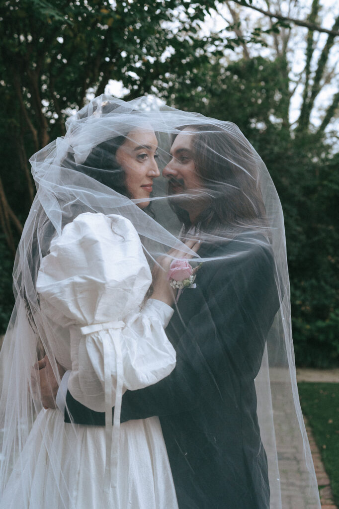 happy newly married couple kissing during their photoshoot