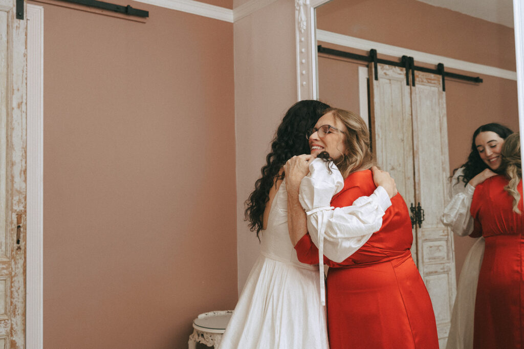 cute picture of the bride and her mother hugging - coquette themed wedding