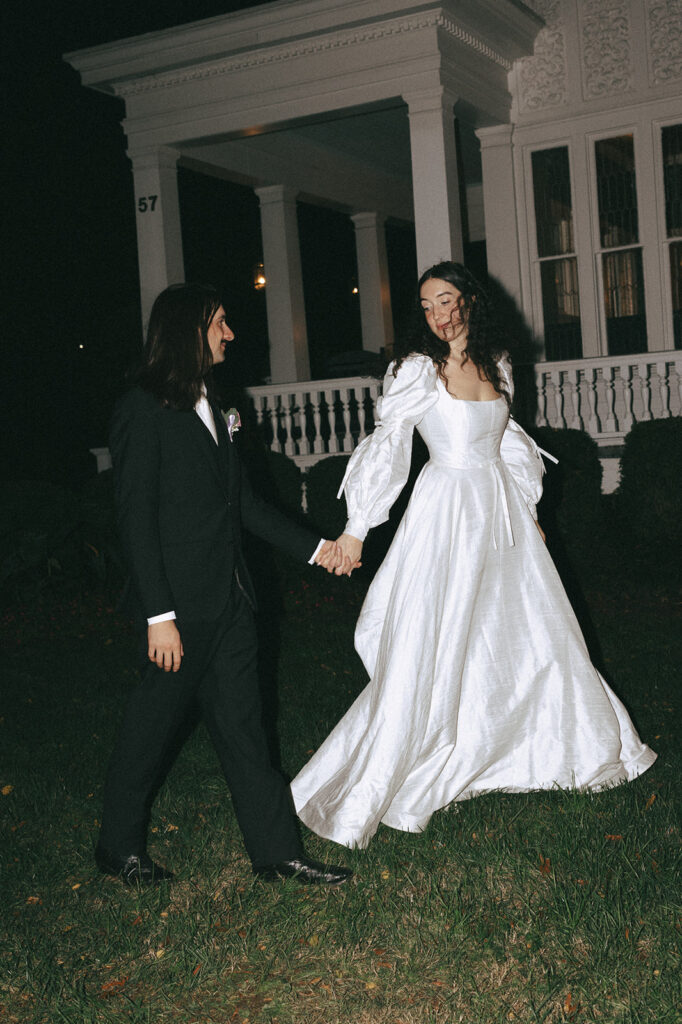 bride and groom walking around their wedding reception