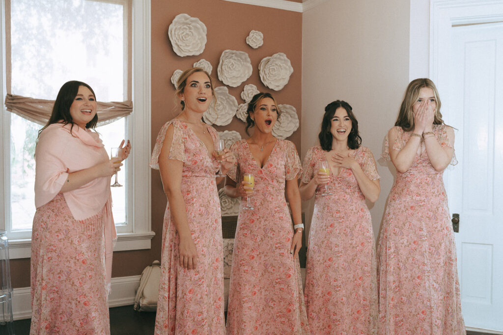 sweet reaction of the bridesmaids seeing the bride in her wedding dress