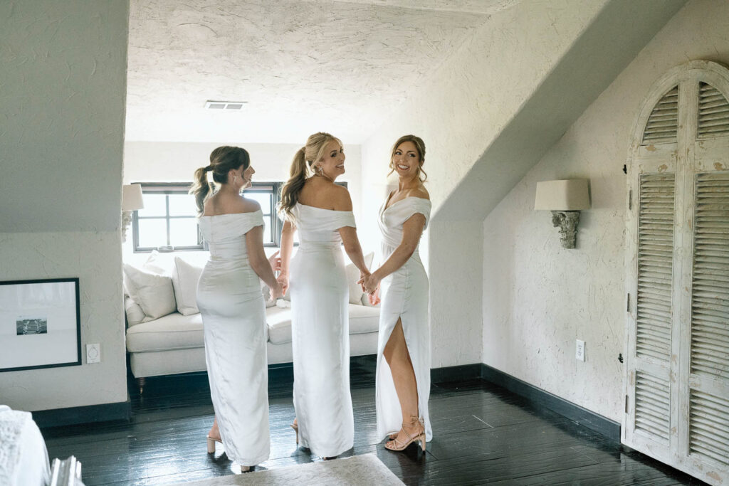 cute reaction of the bridesmaids seeing the bride in her wedding dress